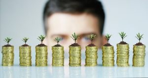 Stacks of coins with little plants growing from top