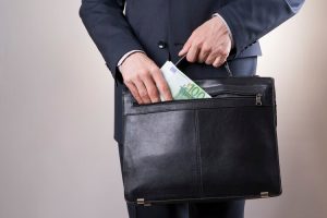 Businessman with briefcase and $100 bill