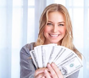 Woman holding fan of cash