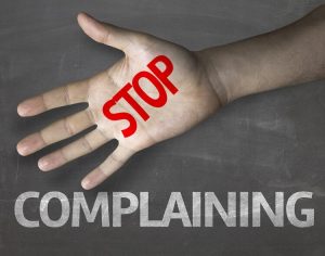 Stop complaining written on hand